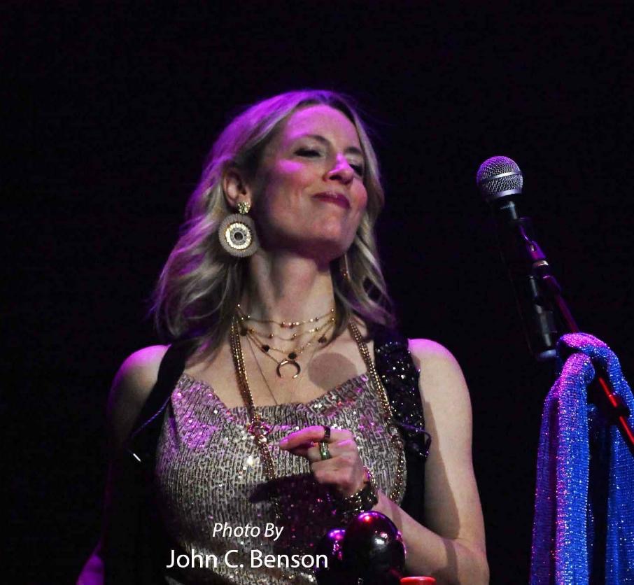 Mia Ossa Praught performing under purple stage lights; photo by John C. Benson
